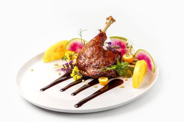 istock Chicken with vegetables on white plate served topped with berry sauce 892458092