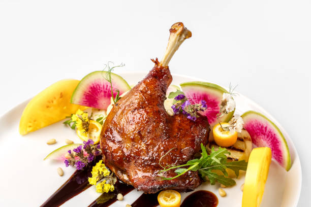 istock Chicken with vegetables on white plate served topped with berry sauce 892458142