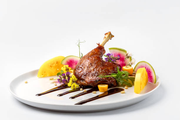 istock Chicken with vegetables on white plate served topped with berry sauce 892458162