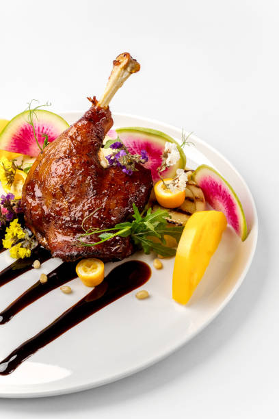 istock Chicken with vegetables on white plate served topped with berry sauce 892458178