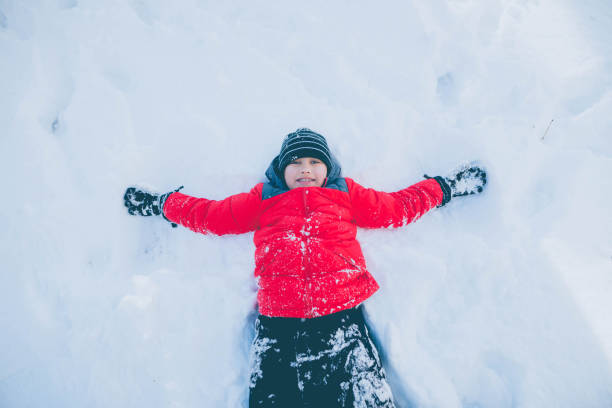 istock Little Boy Angel in Snow 892460638