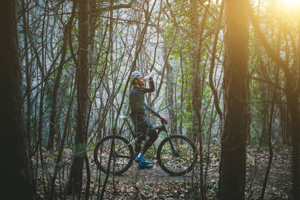 istock Biker taking a break for water from long bike route 892478292