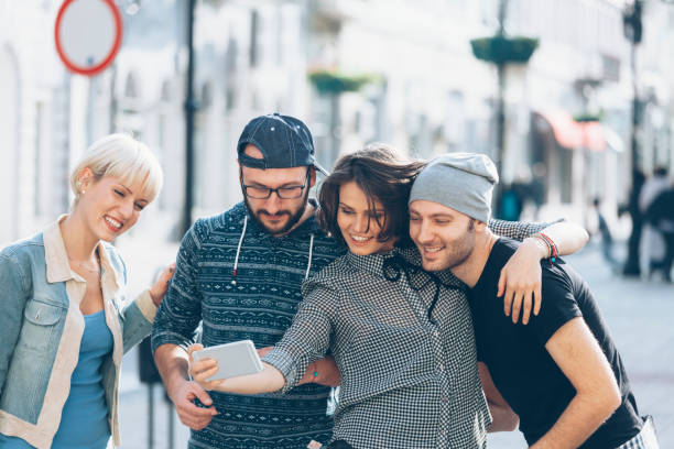 istock Happy tourists making selfie on street 892478382