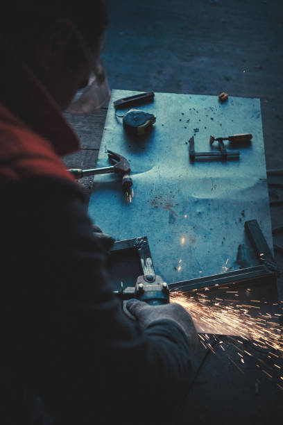 Portraits of a young man welding and grinding steel Portraits of a young man welding and grinding steel. Shallow DOF. welder engineering construction bright stock pictures, royalty-free photos & images