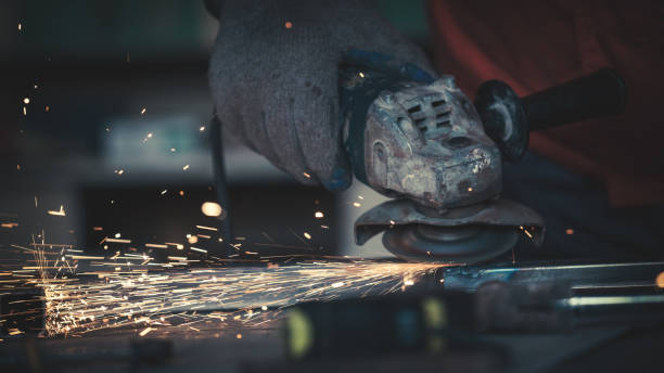 Portraits of a young man welding and grinding steel Portraits of a young man welding and grinding steel. Shallow DOF. welder engineering construction bright stock pictures, royalty-free photos & images