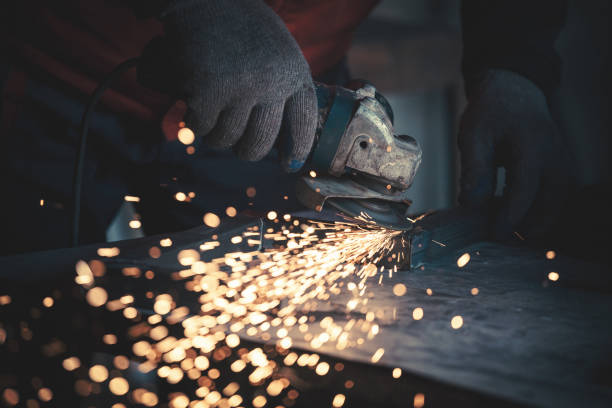 Portraits of a young man welding and grinding steel Portraits of a young man welding and grinding steel. Shallow DOF. welder engineering construction bright stock pictures, royalty-free photos & images