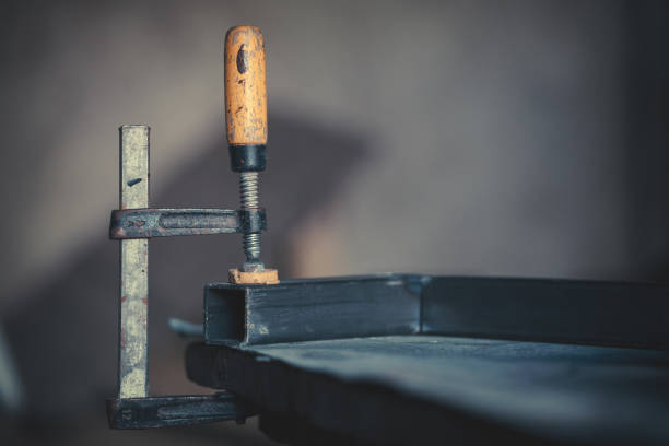 Portraits of a young man welding and grinding steel Portraits of a young man welding and grinding steel. Shallow DOF. welder engineering construction bright stock pictures, royalty-free photos & images