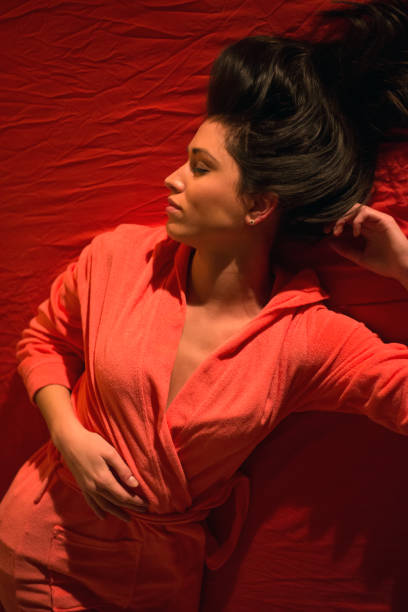 istock Woman in bathrobe sleeping on bed 892501550