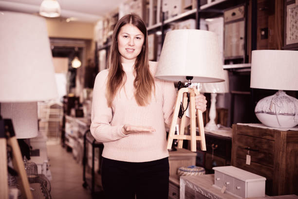istock Smiling woman consumer choosing torchere 892507702