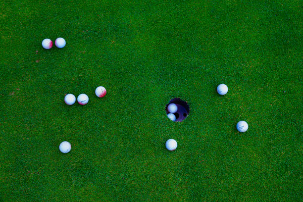 istock golf balls on green grass in golf course 892513296