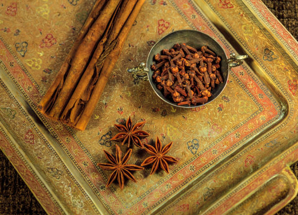 Indian spices  - cinnamon sticks, whole cloves and star anise on brass tray. Indian cuisine; seasonings, flavorings.