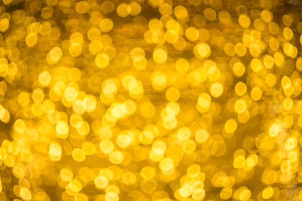 istock blured Christmas light  on gold abstract lights bokeh background 892536428