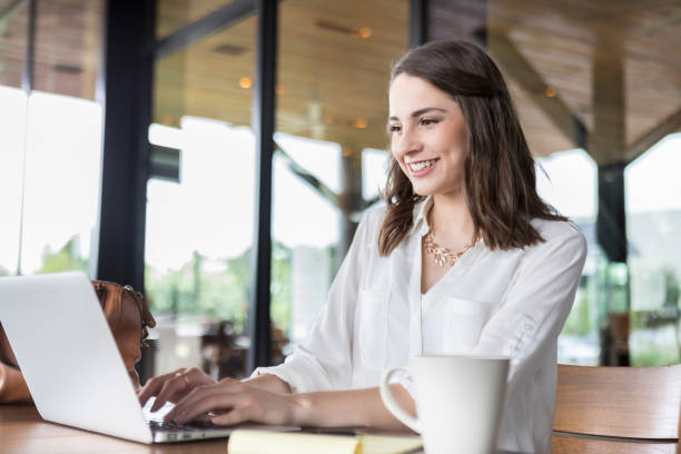 istock Young student studies with laptop in coffee shop 892541426