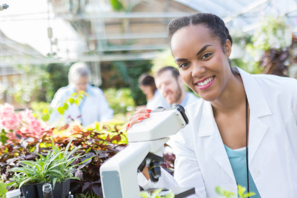 istock Cheerful female scientist in plant nursery 892541494