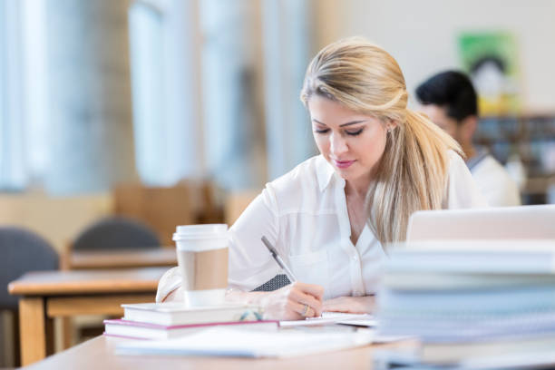 istock Adult student studies in college library 892541840