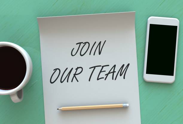 istock JOIN OUR TEAM, message on paper, smart phone and coffee on table 892550344