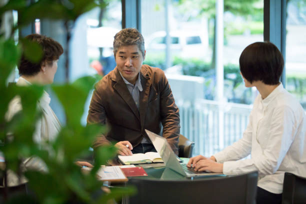 istock Various age Asian business team are meeting around the table 892550644