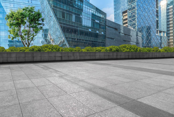 istock Empty brick road front of office building at night 892558636