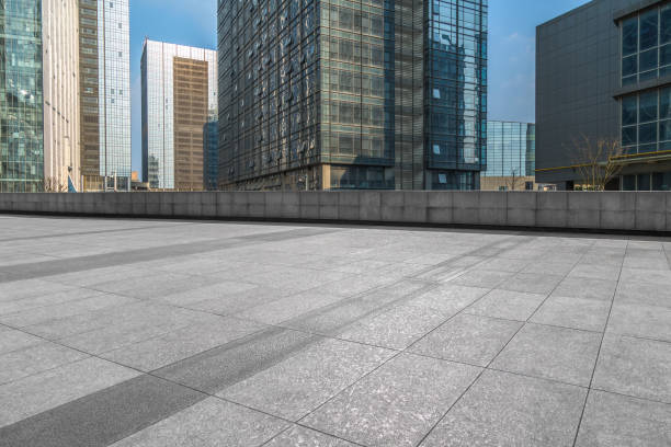 istock Empty brick road front of office building at night 892558646