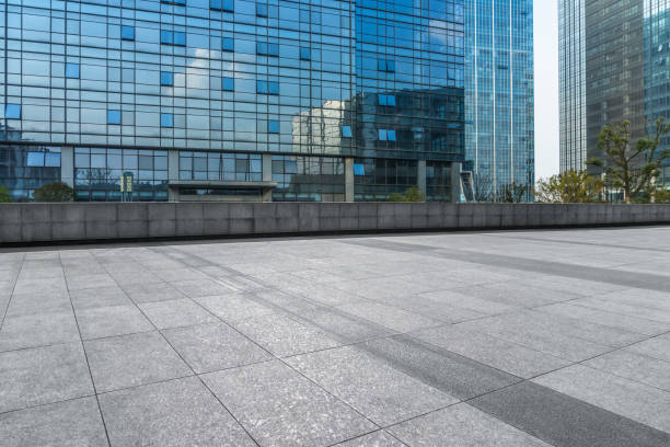 istock Empty brick road front of office building at night 892561330