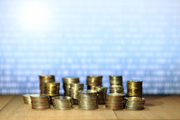 istock Digital economy. Coin stack with blue binary digital numbers background. Business, finance and saving concept. 892573392