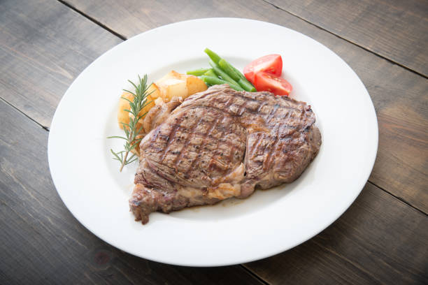 boneless rib eye steak on plate boneless rib eye steak on plate rib eye steak stock pictures, royalty-free photos & images