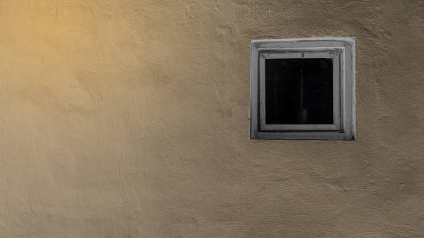istock Small window on a plastered wall of rustic house in vintage tone 892591284