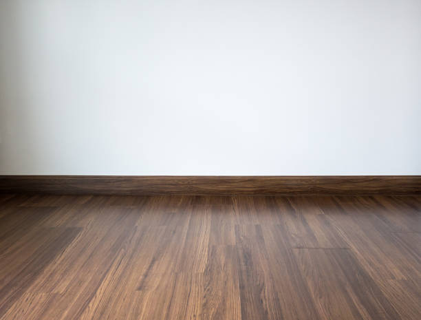 istock Empty room with laminate floor and white wall background 892598948