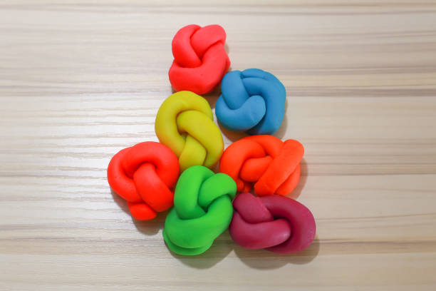 istock colorful playdough close up image on wooden table. 892604060