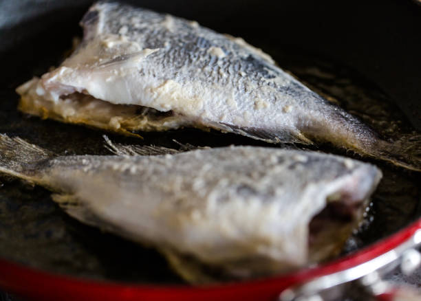 istock Sea Bream fried in deep oil on red skillet 892625140
