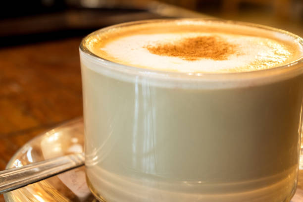 istock coffee cup with milk froth on wooden table 892625576