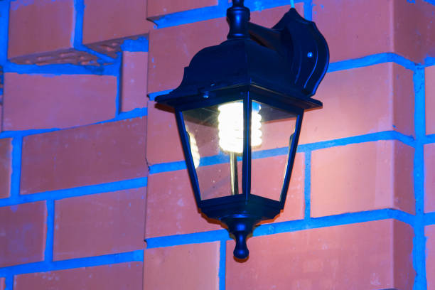 istock Magic lantern of artificial lighting on a wall of red bricks in the dark 892629734