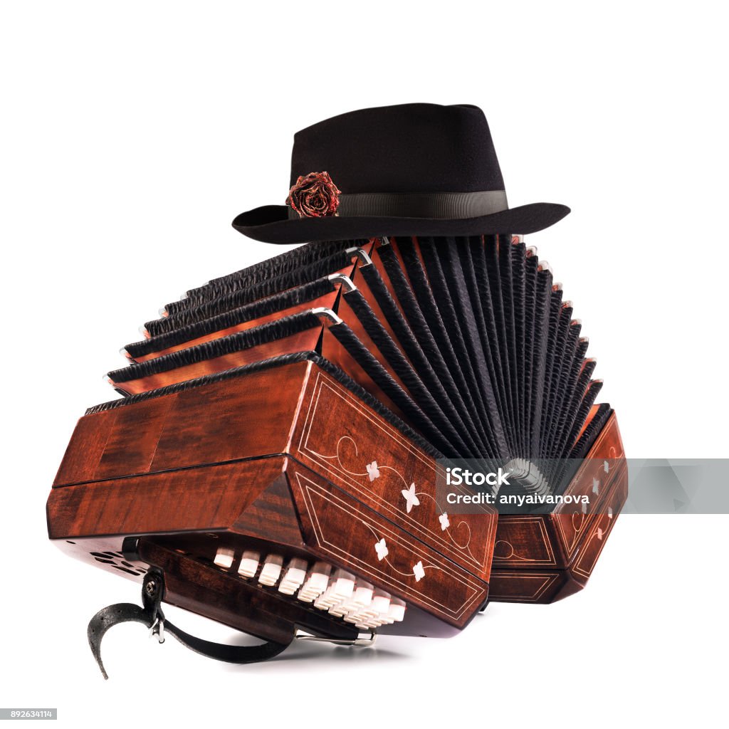 Bandoneón, instrumento de tango con un sombrero masculino en la parte superior en blanco - Foto de stock de Bandoneón libre de derechos