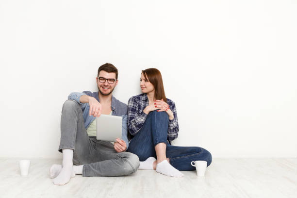 istock Smiling couple web-surfing on tablet, studio shot 892639168