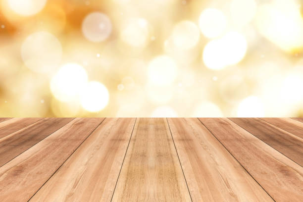 istock Wood table top on gleam shiny gold bokeh abstract background 892643592