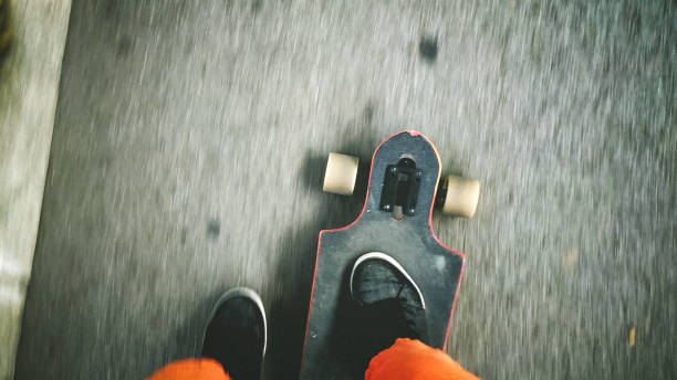 istock longboarder driving on the street 892644476