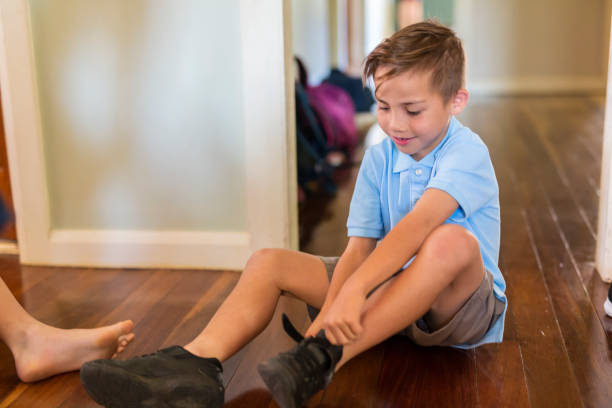 istock School Children Putting Shoes On 892657954