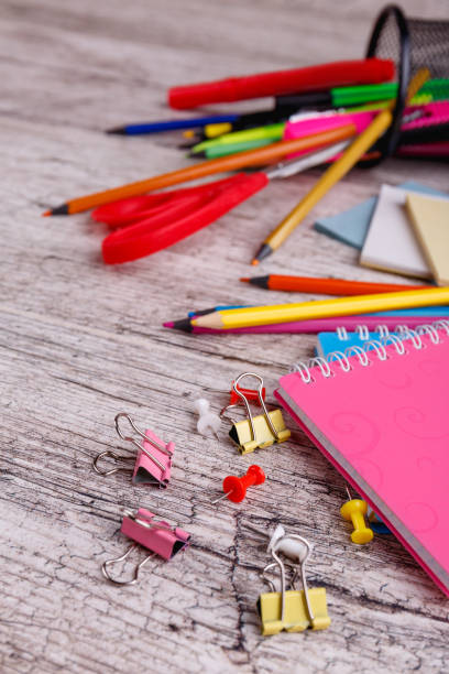 istock Scattered office supplies close-up on a wooden table 892662966