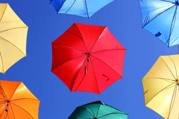 istock colorful umbrellas against blue sky 892668268