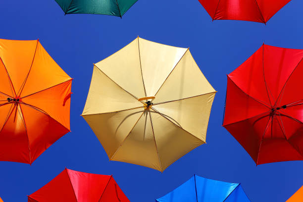 istock colorful umbrellas against blue sky 892668286