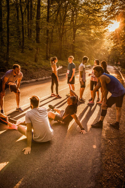 istock Large group of marathon runners talking on a break at sunset. 892668410