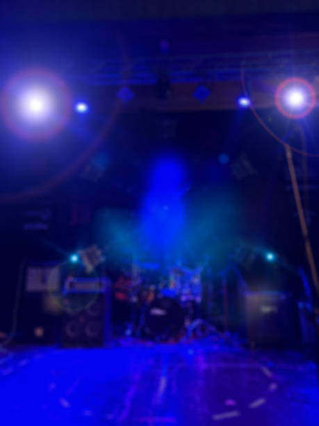 istock De-focused concert stage with laser lights and beams. 892674082