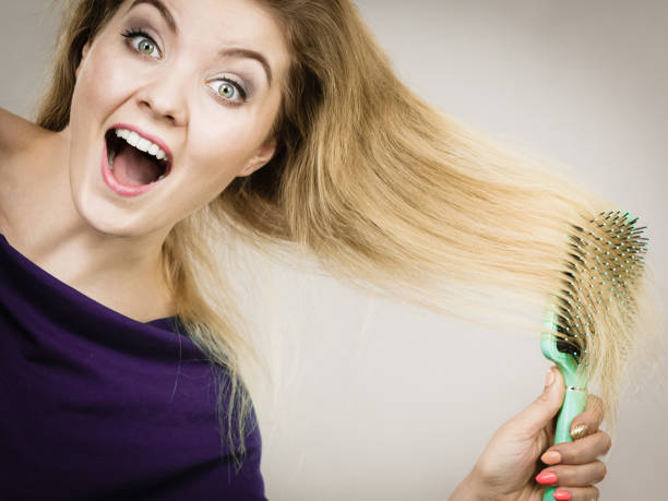 istock Woman brushing her long hair with brush 892674416
