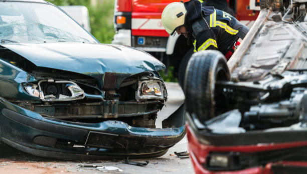 Firefighters At A Car Accident Scene Firefighters At A Car Accident Scene road accident stock pictures, royalty-free photos & images