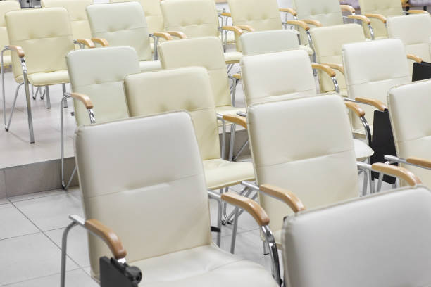 istock background of empty row of white chairs in the conference hall. 892686436