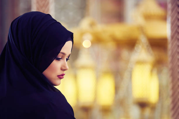 istock muslim woman praying in mosque 892689156