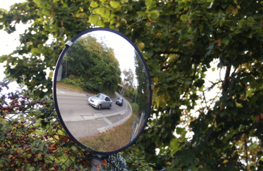 Curved mirror installed at an intersection on a country road