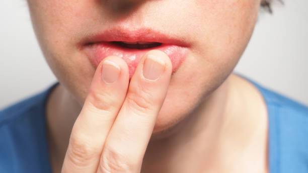 istock Covering mouth with fingers 892694026