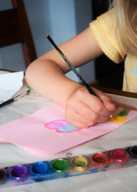 istock Child making homemade greeting card 892694072