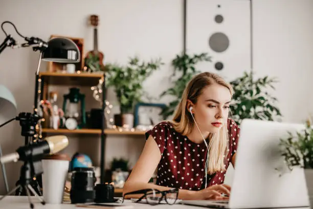 Photo of Young woman editing her vodcast